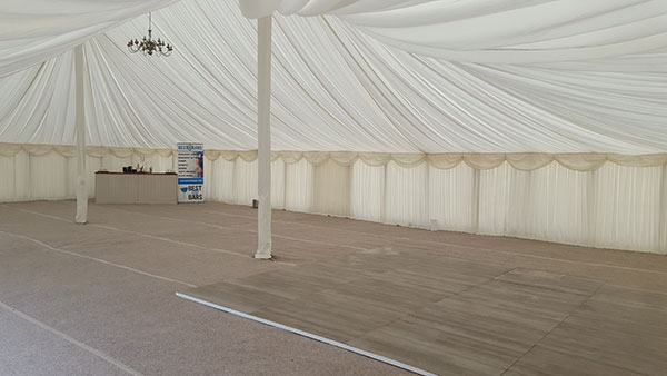 The interior of a solid, semi-permanent marquee for wedding and event hire. 